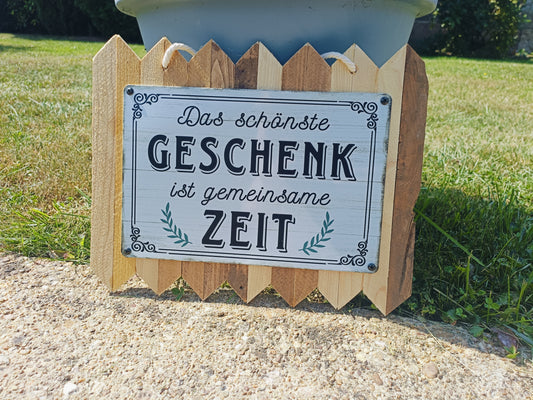 Metal sign “The most beautiful gift is time together”, on old wood